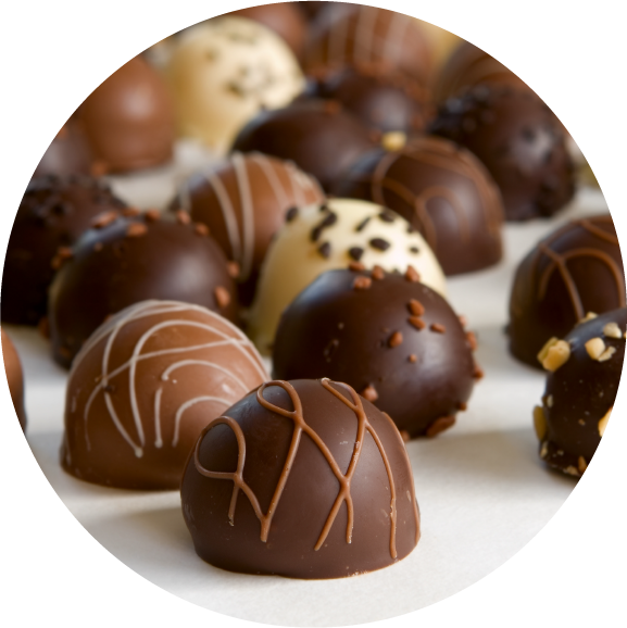 chocolate truffle background - focus on front truffle